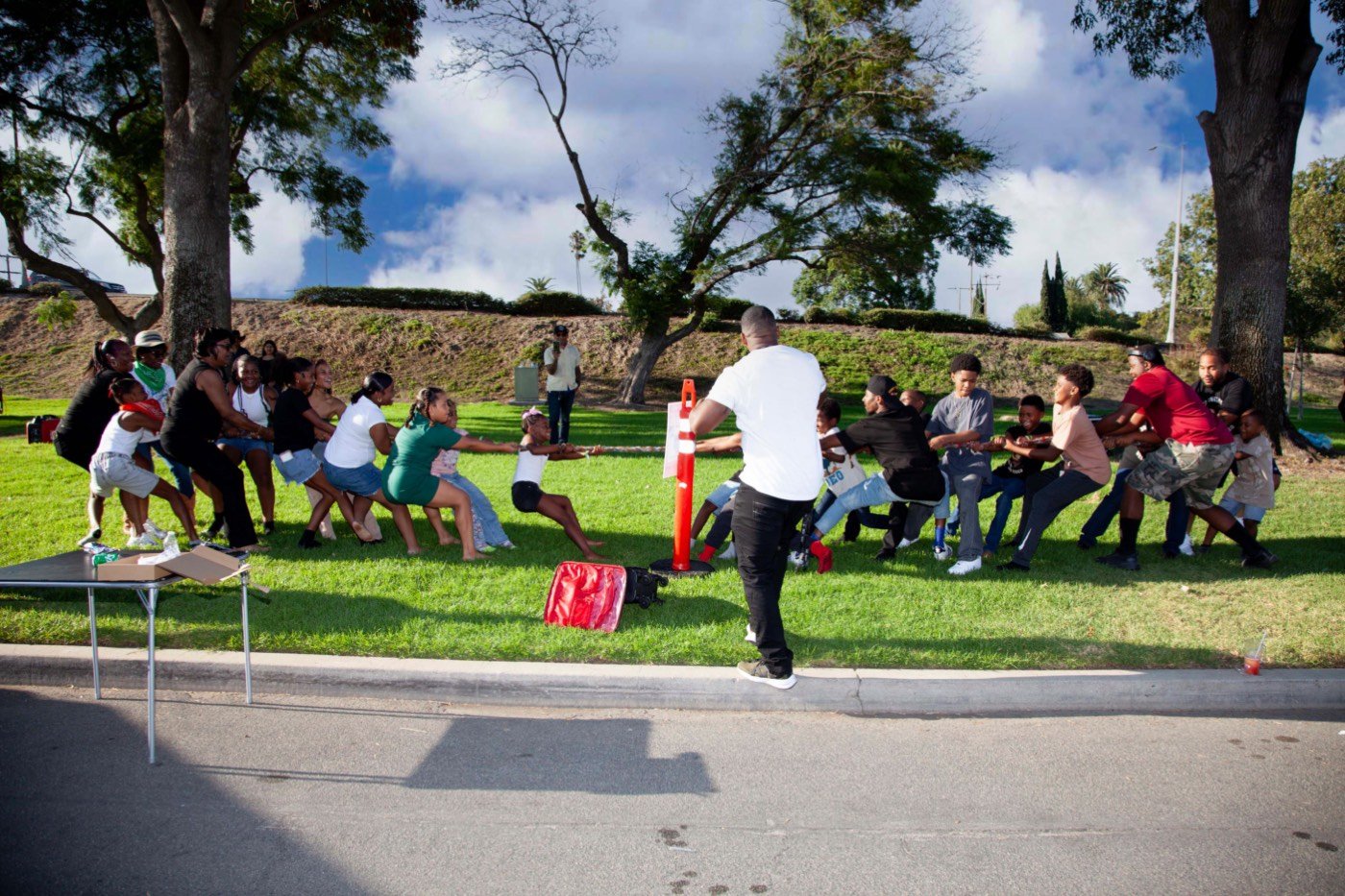 Neighbors and kids playing tug-of-war at the block party